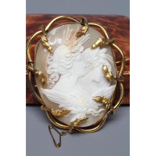 309 - A VICTORIAN SHELL CAMEO carved as Artemis with the eagle of Zeus, in a gilt metal leafy brooch mount... 