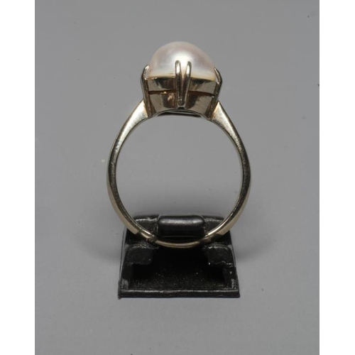 312 - A PEARL DRESS RING, the mabe pearl claw set to a white shank stamped 9ct, sponsor's mark ?E&S, size ... 