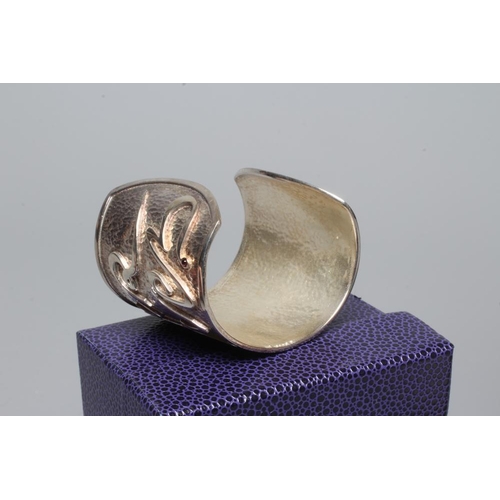 314 - A MODERN WIDE SILVER CUFF by Hamilton & Inches, Edinburgh 2002, cast in low relief with 'Mon Coeur A... 