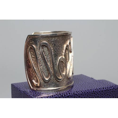 314 - A MODERN WIDE SILVER CUFF by Hamilton & Inches, Edinburgh 2002, cast in low relief with 'Mon Coeur A... 