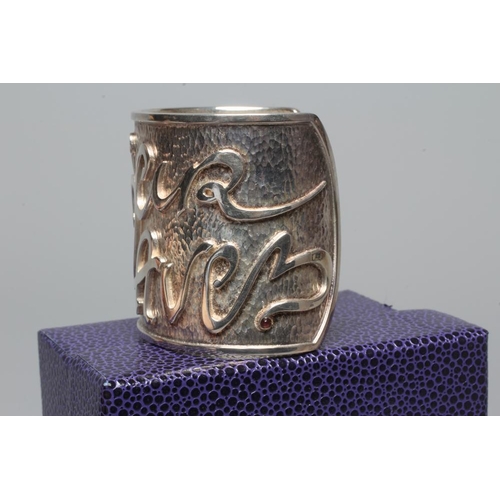 314 - A MODERN WIDE SILVER CUFF by Hamilton & Inches, Edinburgh 2002, cast in low relief with 'Mon Coeur A... 