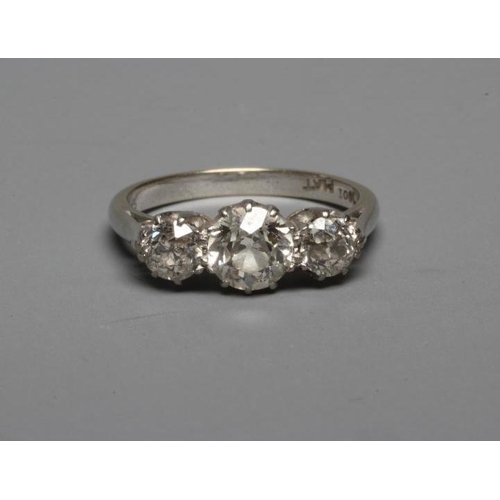 322 - A THREE STONE DIAMOND RING, the central brilliant cut stone of approximately 0.70cts flanked by two ... 