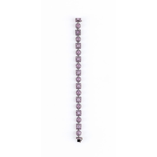 327 - A PINK SAPPHIRE BRACELET with eight square and nine circular stone set clusters to a white frame wit... 