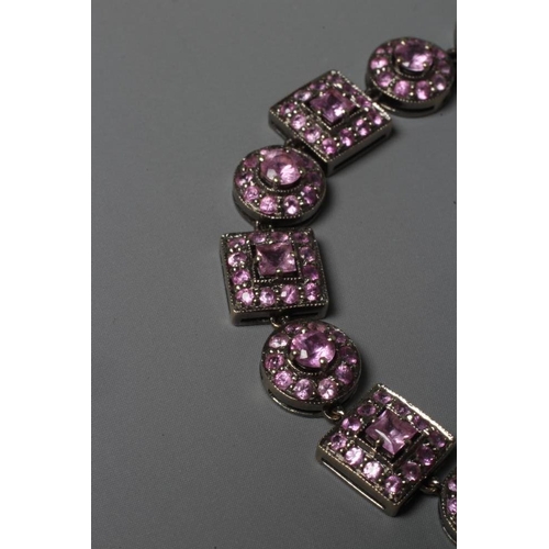 327 - A PINK SAPPHIRE BRACELET with eight square and nine circular stone set clusters to a white frame wit... 