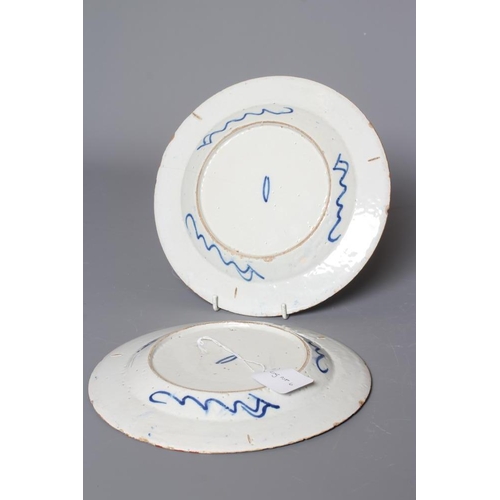 35 - A PAIR OF DELFT PLATES, possibly Lambeth c.1755, of plain circular form centrally painted in blue wi... 