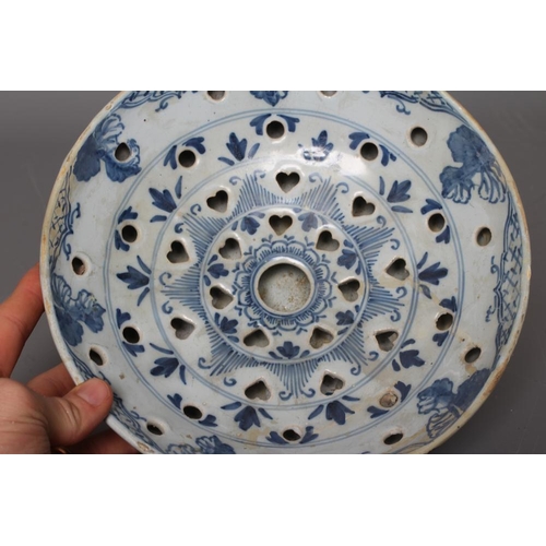 38 - A DELFT COLANDER BOWL, probably London c.1750, of plain circular form, the exterior painted in blue ... 