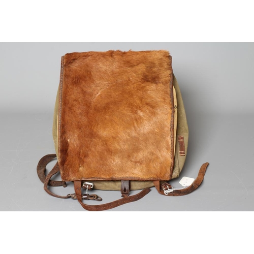 386 - A GERMAN WWII TORNISTER BACKPACK, the canvas body with leather strapping, stamped 