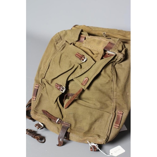 386 - A GERMAN WWII TORNISTER BACKPACK, the canvas body with leather strapping, stamped 