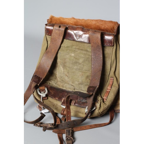 386 - A GERMAN WWII TORNISTER BACKPACK, the canvas body with leather strapping, stamped 