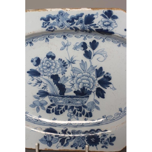 39 - A DELFT DISH, probably Liverpool c.1780, of canted oblong form with oval centre painted in blue with... 