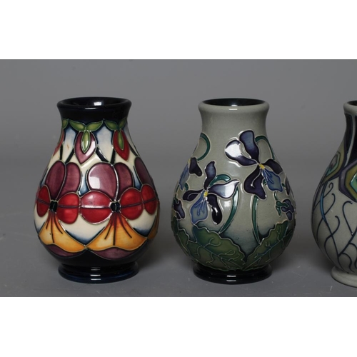 48 - FOUR MOORCROFT POTTERY VASES all of baluster form and comprising Violetta, 2012, and Shrinking Viole... 