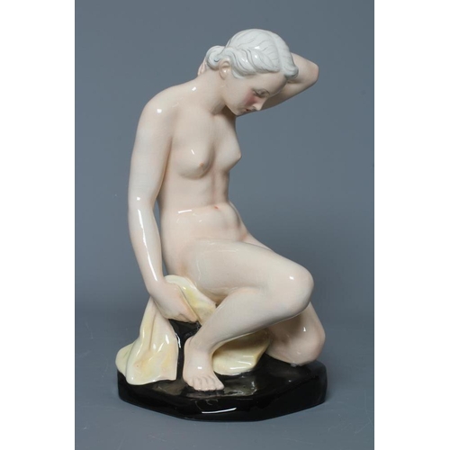 58 - F. WINKLER FOR GOEBEL- an earthenware female nude, modelled kneeling on her left leg, her left arm t... 