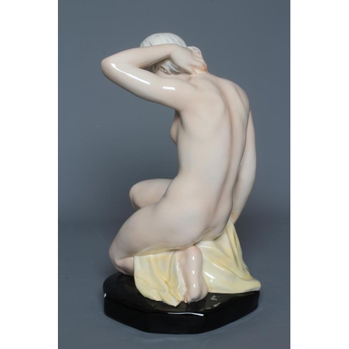 58 - F. WINKLER FOR GOEBEL- an earthenware female nude, modelled kneeling on her left leg, her left arm t... 