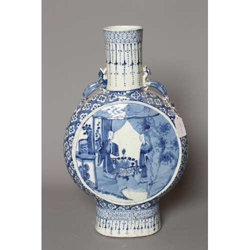 6 - A LARGE CHINESE MOONFLASK painted in underglaze blue with two ladies on a verandah, within a flowerh... 