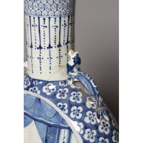 6 - A LARGE CHINESE MOONFLASK painted in underglaze blue with two ladies on a verandah, within a flowerh... 