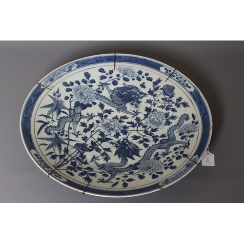 6 - A LARGE CHINESE MOONFLASK painted in underglaze blue with two ladies on a verandah, within a flowerh... 