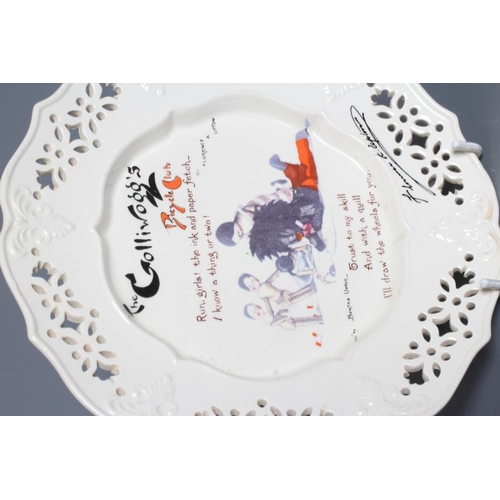 60 - FLORENCE UPTON FOR T & R BOOTE, early 20th century, a pottery plate with flower pierced rim, and bal... 