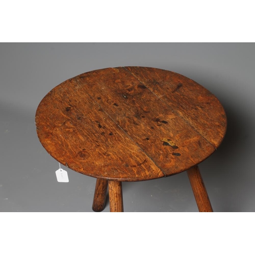 818 - AN OAK CRICKET TABLE, 19th century, the three plank circular top with chamfered lower edge, raised o... 