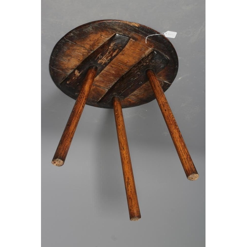 818 - AN OAK CRICKET TABLE, 19th century, the three plank circular top with chamfered lower edge, raised o... 