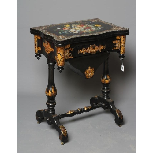 827 - A VICTORIAN PAPIER MACHE WORK/GAMES TABLE, third quarter 19th century, the oblong serpentine top pai... 