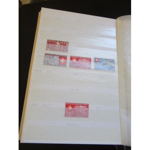 783 - FOUR ALBUMS OF MINT AND USED SWISS STAMPS