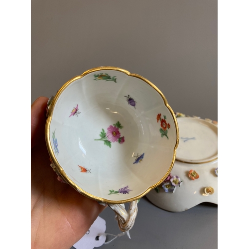 24 - A MEISSEN PORCELAIN CABINET CUP AND SAUCER of lobed form raised upon four peg feet, encrusted and pa... 