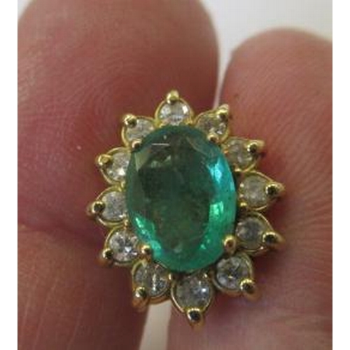 306 - A PAIR OF EMERALD AND DIAMOND CLUSTER EAR STUDS, the oval facet cut emeralds each claw set to a bord... 