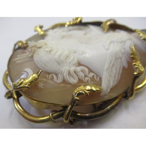 309 - A VICTORIAN SHELL CAMEO carved as Artemis with the eagle of Zeus, in a gilt metal leafy brooch mount... 