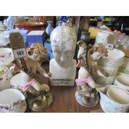 102 - PHRENOLOGY HEAD AND A PAIR OF CHERUB CANDLESTICKS