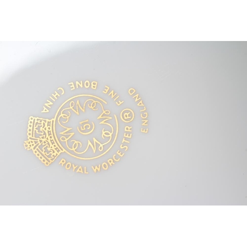 30 - A ROYAL WORCESTER CABINET PLATE, 1960's, of plain circular form, centrally painted with a lotus shap... 