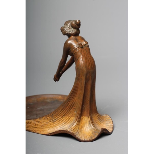 493 - AN ART NOUVEAU PATINATED COPPER FIGURAL DISH modelled as a young lady wearing a flowing dress, leani... 