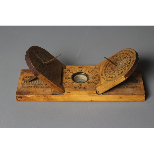 500 - A CHINESE WOOD COMPASS FLANKED BY TWO SUNDIALS, 19th century, the inclining sundials with iron needl... 