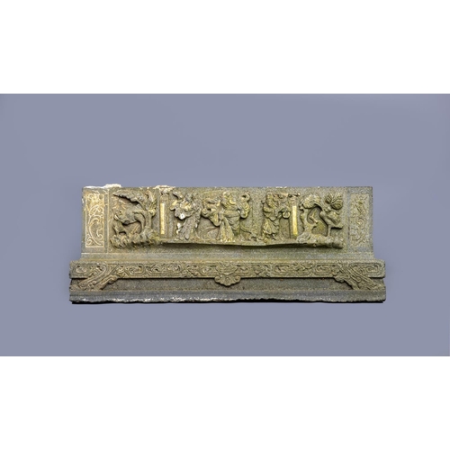 506 - AN INDO-CHINESE GRANITE(?) OBLONG TEMPLE FRIEZE PANEL carved with three deities flanked on one side ... 
