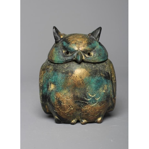 507 - A JAPANESE GREEN PATINATED METAL OWL BOX, modern, the head forming the cover, with gilded highlights... 