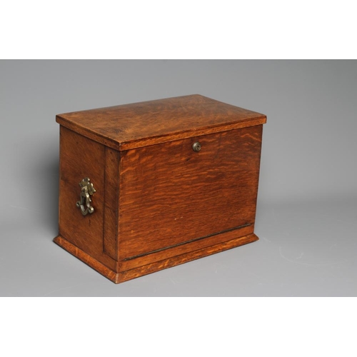 508 - AN EDWARDIAN OAK STATIONERY BOX of oblong form with lightly domed hinged lid and two brass handles, ... 