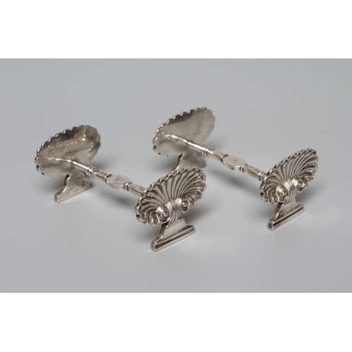 170 - A PAIR OF GEORGE IV SILVER KNIFE RESTS by Emes & Barnard, London 1821, with escallop shell end stand... 