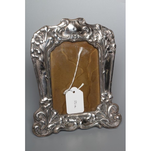 192 - AN EDWARDIAN SILVER STRUT BACK PHOTOGRAPH FRAME by Henry Matthews, Chester 1904, of shaped oblong fo... 