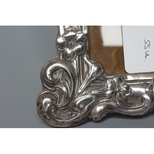 192 - AN EDWARDIAN SILVER STRUT BACK PHOTOGRAPH FRAME by Henry Matthews, Chester 1904, of shaped oblong fo... 