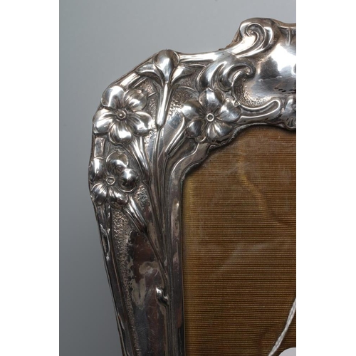 192 - AN EDWARDIAN SILVER STRUT BACK PHOTOGRAPH FRAME by Henry Matthews, Chester 1904, of shaped oblong fo... 