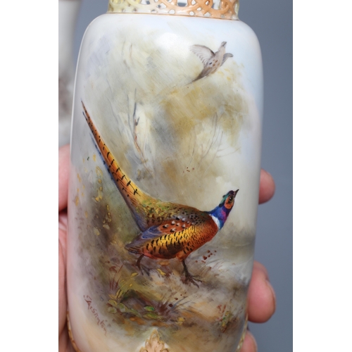 40 - A ROYAL WORCESTER SMALL VASE, 1913, of baluster form with basket weave moulded lower section, painte... 