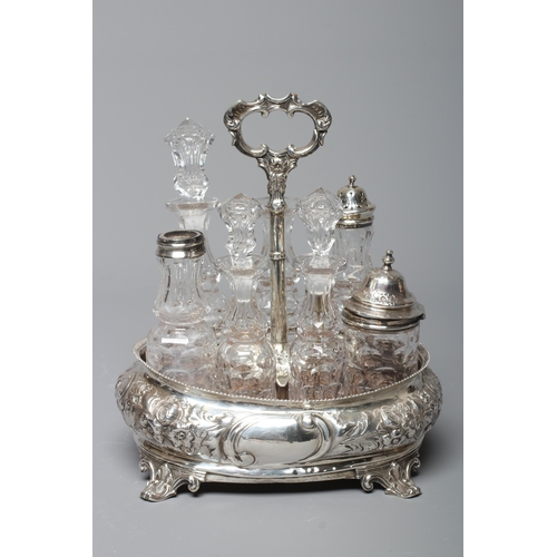 144 - A VICTORIAN SILVER SIX BOTTLE CRUET by Thomas Smily, London 1858, of oval bombe form chased with flo... 