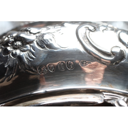 144 - A VICTORIAN SILVER SIX BOTTLE CRUET by Thomas Smily, London 1858, of oval bombe form chased with flo... 