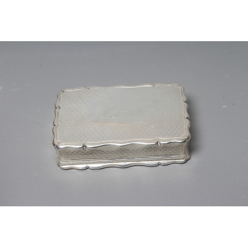 150 - AN EARLY VICTORIAN SILVER SNUFF BOX by George Unite, Birmingham 1854, of shaped oblong form with wav... 