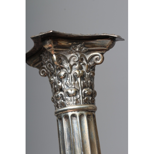 169 - A PAIR OF GEORGE V SILVER CORINTHIAN CANDLESTICKS by Fenton, Russell & Co. Ltd., Sheffield 1911, wit... 
