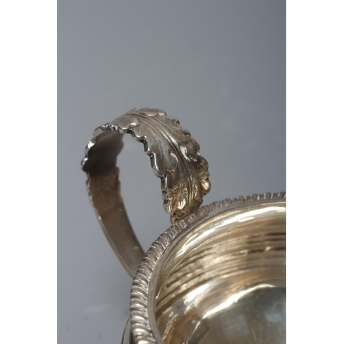 186 - A GEORGE IV SILVER MILK JUG by William M Traies, London 1825, the squat globular reeded body with ca... 