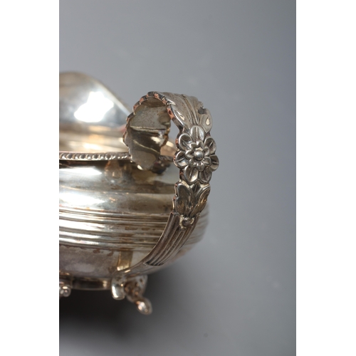 186 - A GEORGE IV SILVER MILK JUG by William M Traies, London 1825, the squat globular reeded body with ca... 