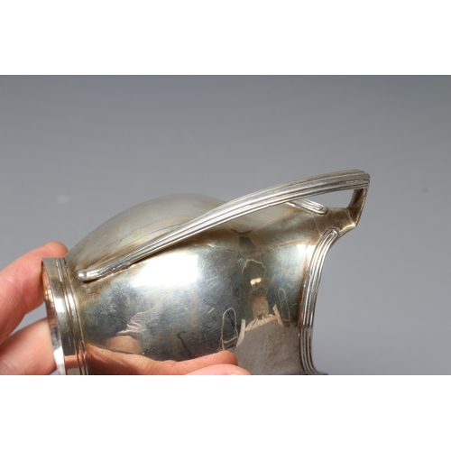 186 - A GEORGE IV SILVER MILK JUG by William M Traies, London 1825, the squat globular reeded body with ca... 