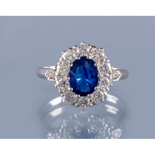 316 - A SAPPHIRE AND DIAMOND CLUSTER RING, the oval facet cut sapphire of approximately 1.50cts, claw set ... 