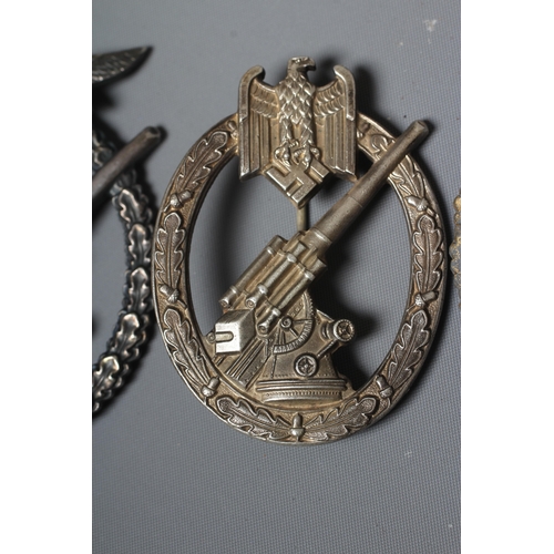402 - THREE GERMAN THIRD REICH BADGES, comprising a Coastal Artillery badge with marks for Fec. Otto Placz... 