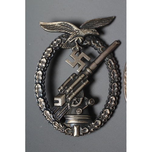 402 - THREE GERMAN THIRD REICH BADGES, comprising a Coastal Artillery badge with marks for Fec. Otto Placz... 